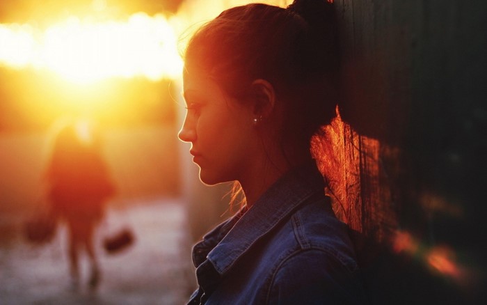 Woman in denim jacket at sunset
