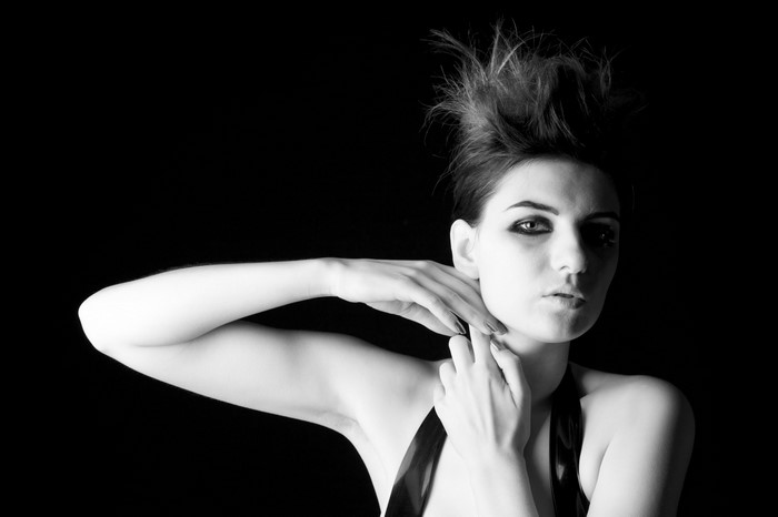 Monochrome portrait of a woman with dramatic makeup and hairstyle
