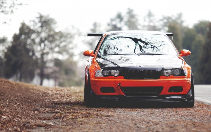 Orange BMW M3 E46 with black hood and spoiler