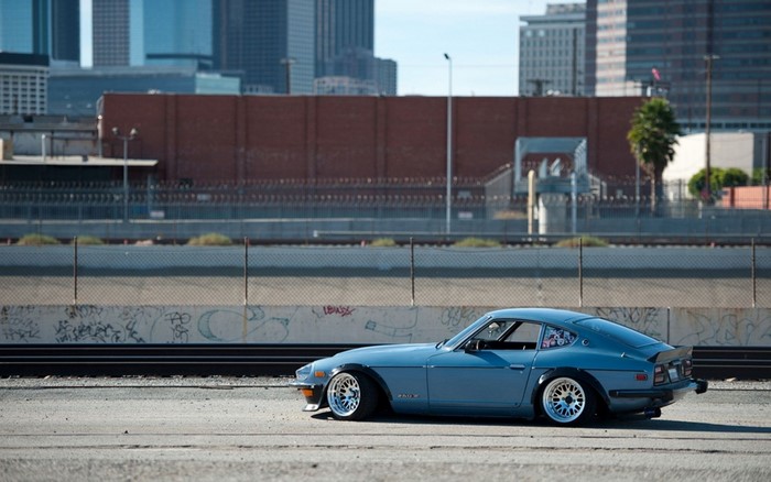 Blue Datsun 240Z sports car with custom wheels