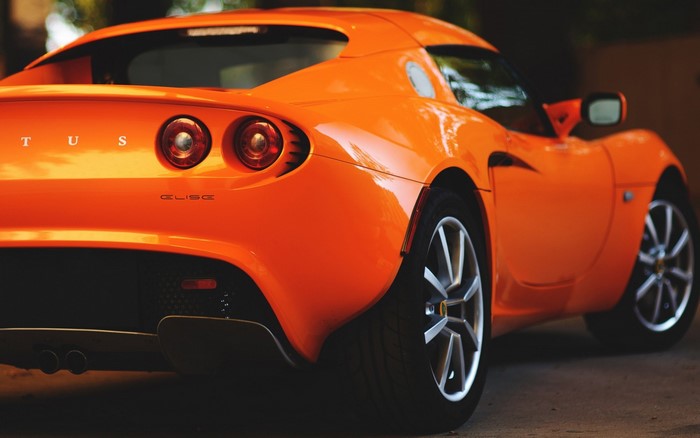 Orange Lotus Elise sports car rear view