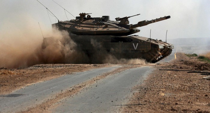 Merkava Mark IV tank driving on a dirt road