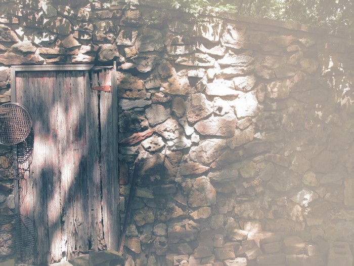 Old wooden door on a stone wall