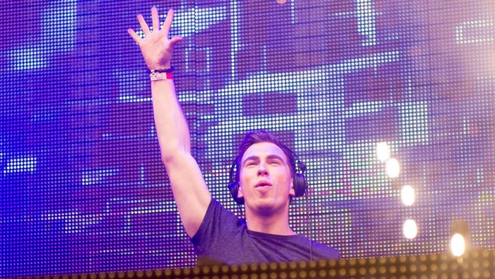 DJ Hardwell performing on stage with a light display