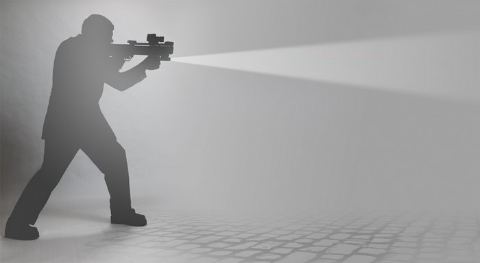 Silhouette of a man holding a KSG 12 shotgun with a light beam