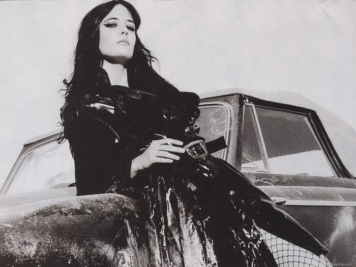 Eva Green posing by a vintage car