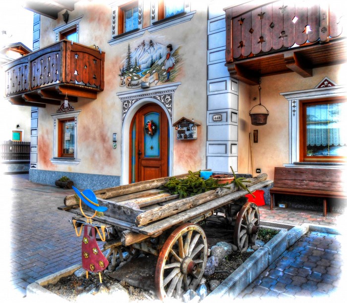 Wooden cart in front of a decorated house