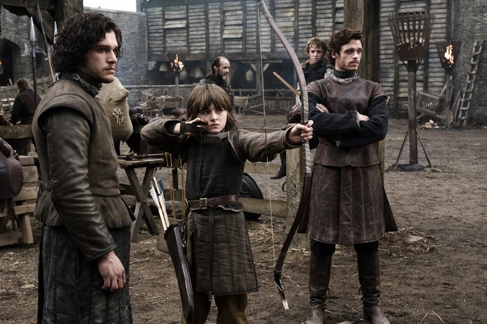 Jon Snow and Robb Stark watch Bran Stark practice archery in Game of Thrones