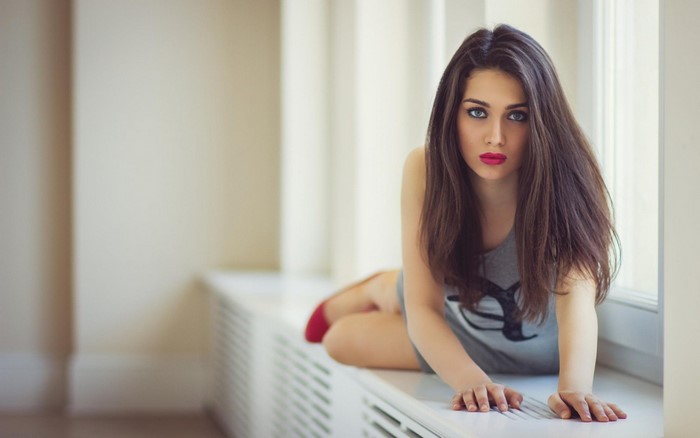 Woman with long brown hair and blue eyes