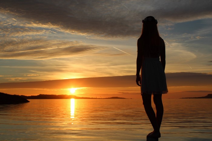 Silhouette of a woman at sunset over the sea