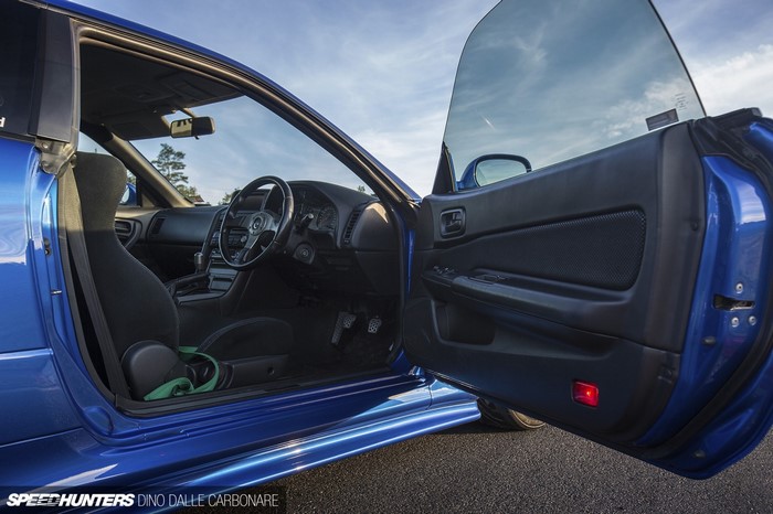 Blue sports car interior with open door
