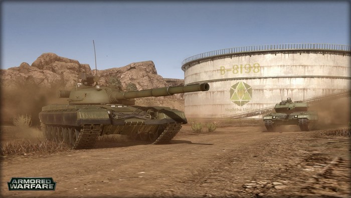 Tanks in a desert landscape near a large industrial tank