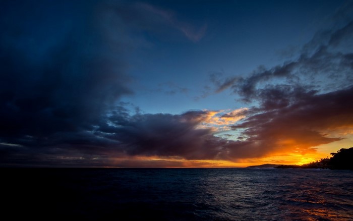 Sunset over the ocean with dramatic clouds