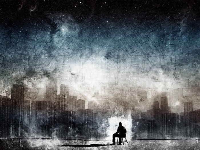 Silhouette of a person sitting in a chair overlooking a futuristic cityscape under a starry sky