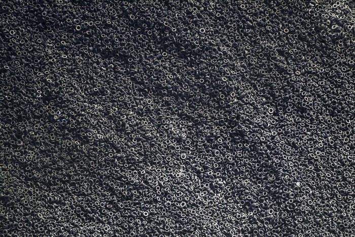 Aerial view of a large pile of black tires