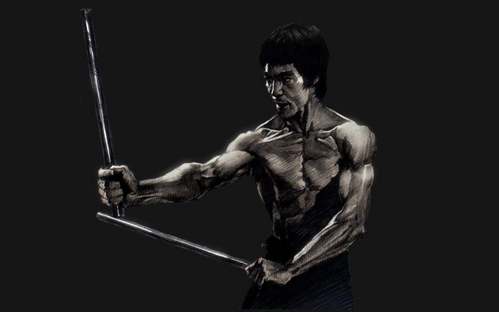 Bruce Lee holding nunchucks