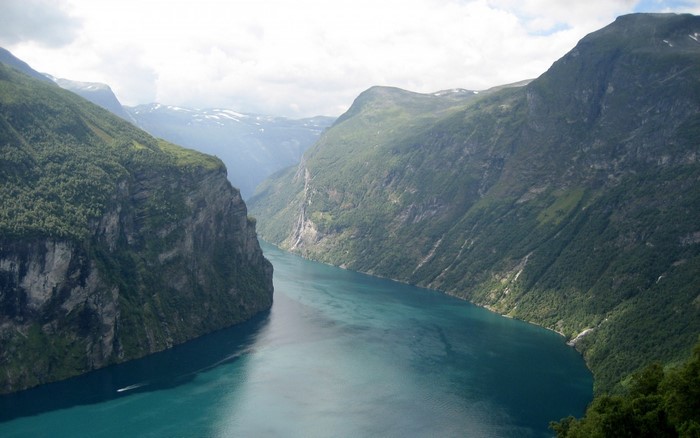 Geiranger Fjord with steep mountains and a boat