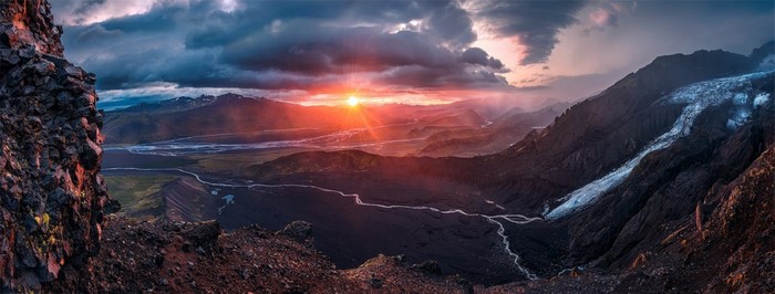 Sunset over a glacial valley with mountains