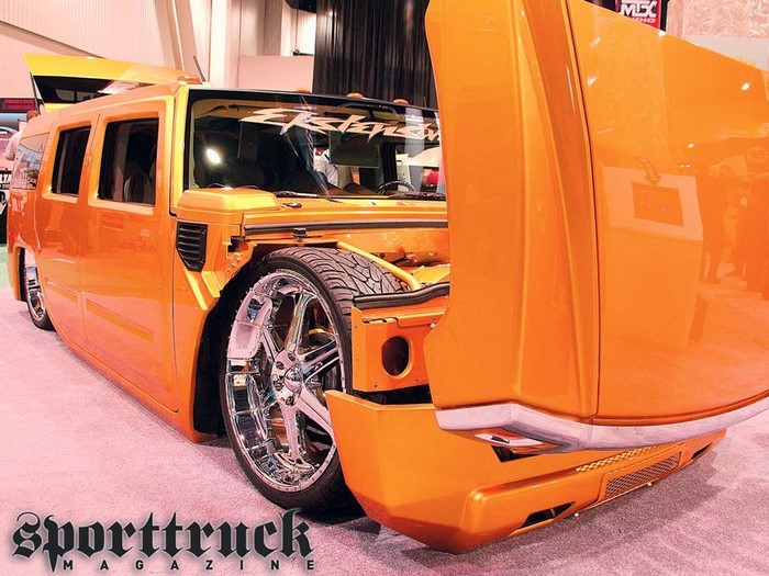 Orange Hummer H2 with custom wheels at Sporttruck Magazine