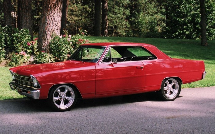 Red Chevrolet Nova parked on a paved road