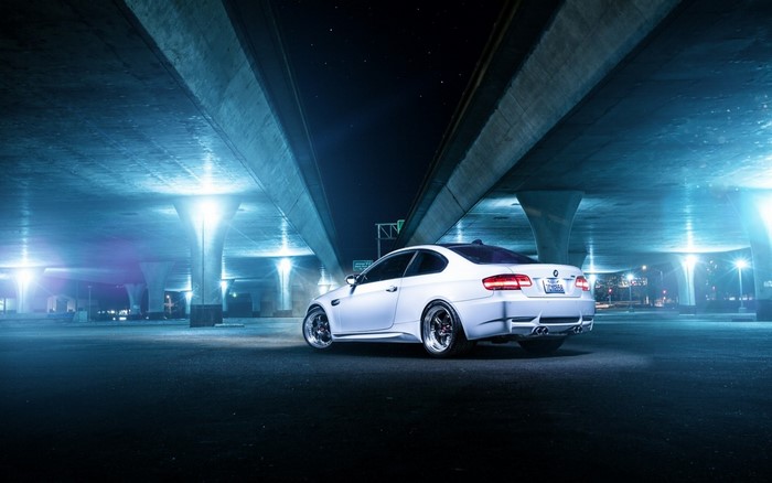 White BMW M3 Coupe parked under a bridge at night