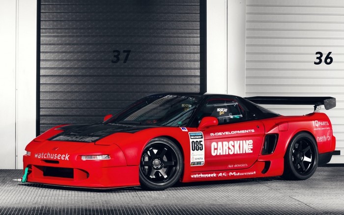Red Honda NSX race car with racing decals