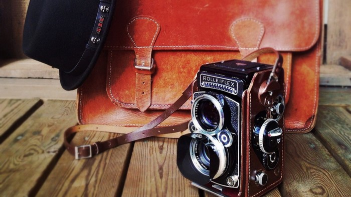 Vintage Rolleiflex camera with leather bag and hat