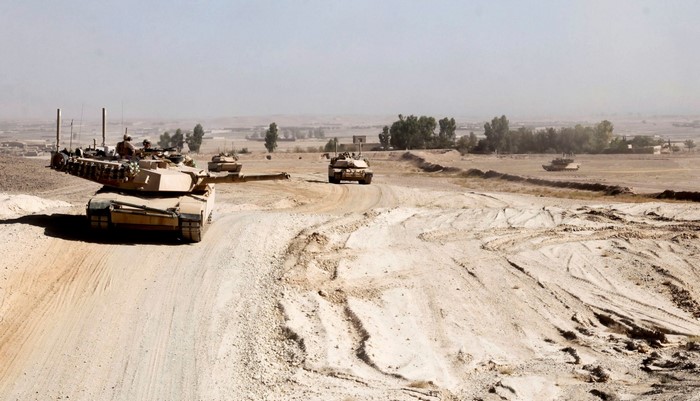 M1 Abrams tanks in a desert landscape