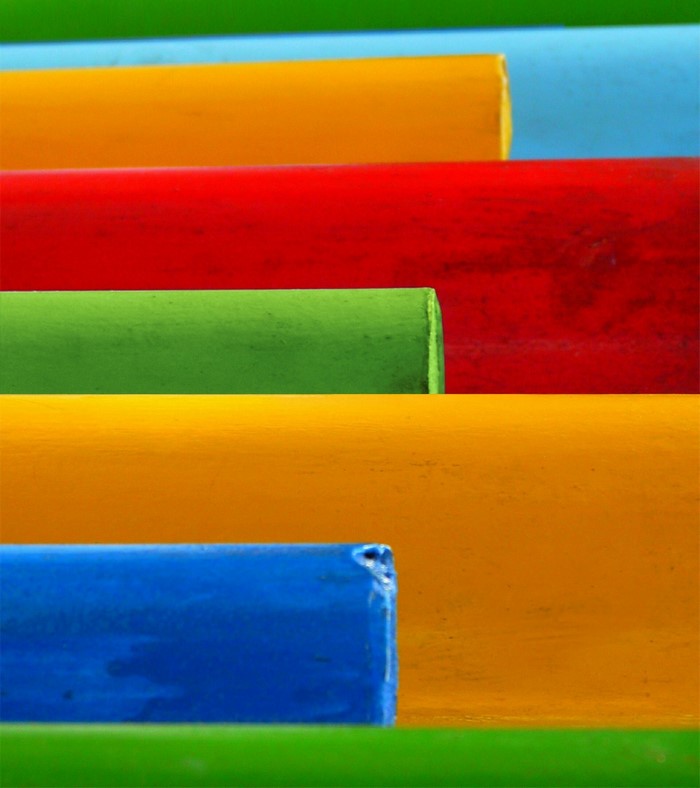 Colorful cylindrical objects arranged in parallel lines