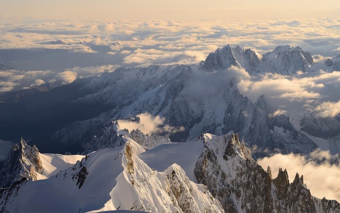 Snow-capped mountains above clouds in the Alps