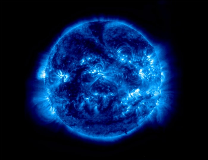 The Sun in blue tones with solar flares