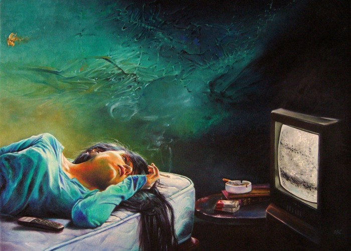Woman smoking in bed watching TV