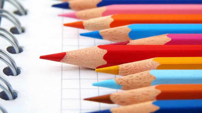 Colorful pencils on a notebook