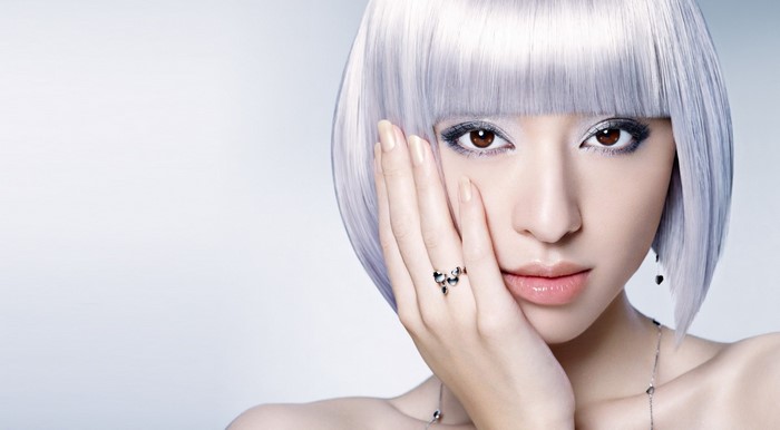 Woman with silver bob wig and dramatic makeup
