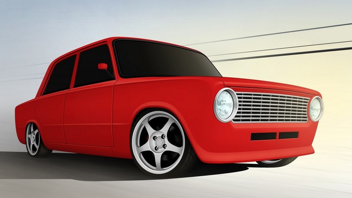 Red sedan with custom wheels on a road