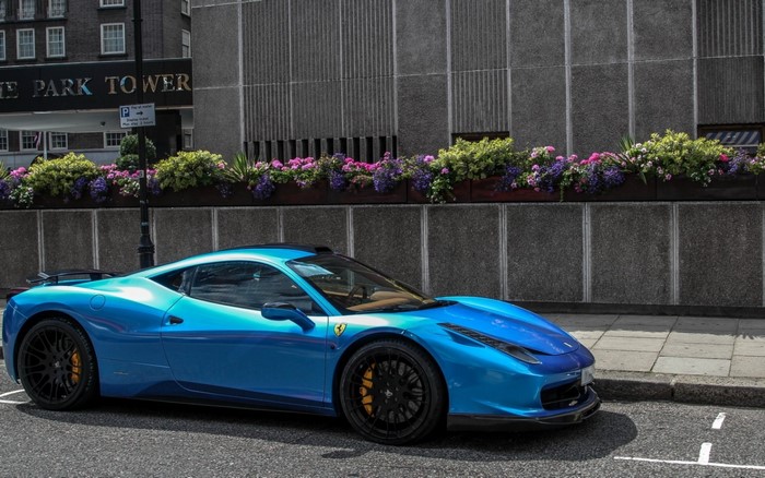 Blue Ferrari 458 parked in front of Park Tower