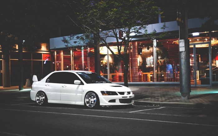 White Mitsubishi Lancer Evolution parked at night