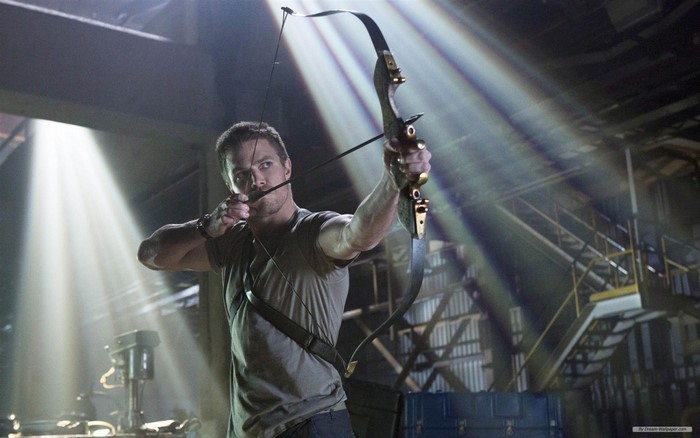 Oliver Queen from Arrow with a bow and arrow