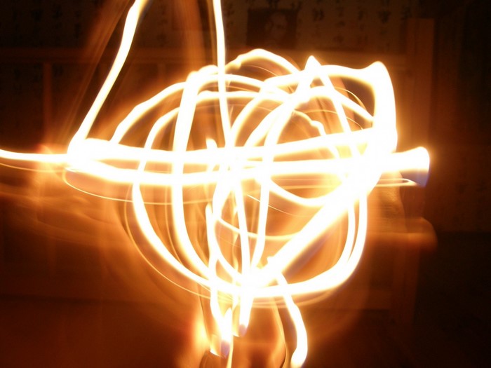 Light painting with sparklers in darkness