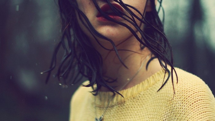 Close up of a woman with wet hair in the rain