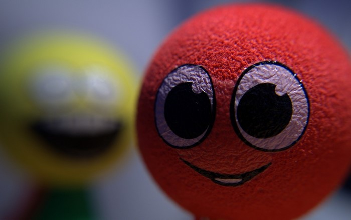 Close up of a red smiley ball toy