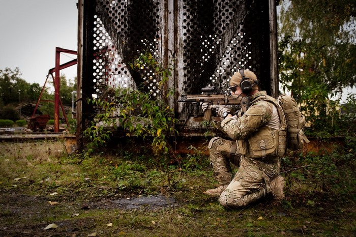 Soldier in camouflage with FN SCAR L rifle
