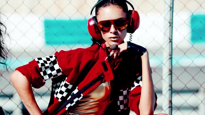 Woman in red racing jacket and headphones