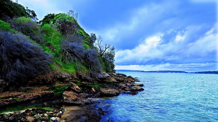 Rocky Coastal Bay Under Cloudy Sky
