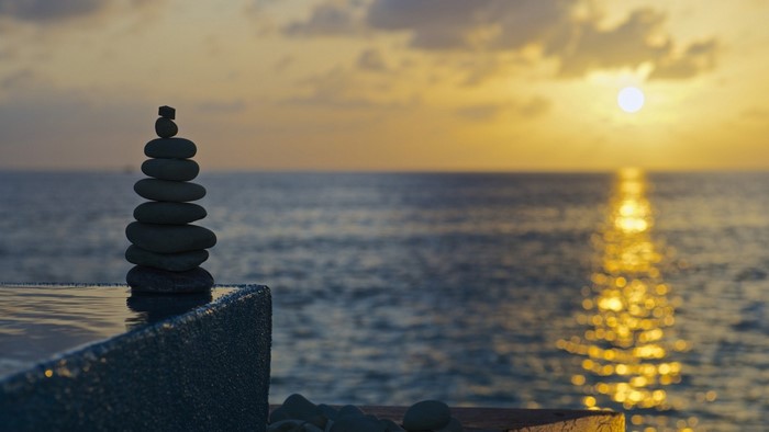 Stack of stones at sunset by the sea
