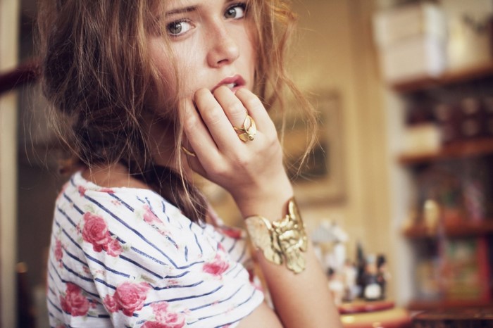 Woman with floral shirt and jewelry