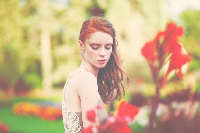 Woman with red hair in a garden