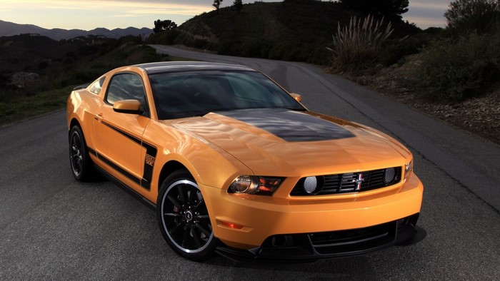 Orange Ford Mustang Boss 302 on a Road