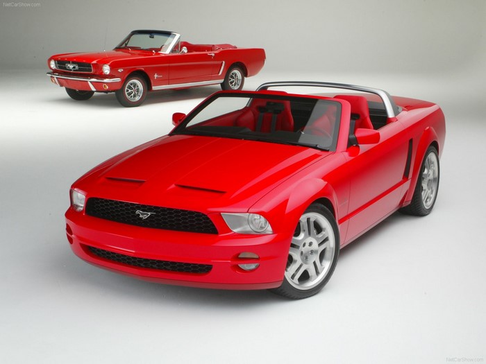 Two red Ford Mustang convertibles, classic and modern