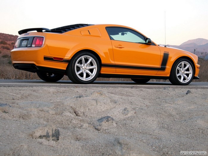 Orange Ford Mustang Boss 302 parked on a road